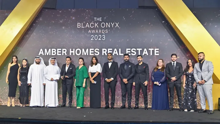 Ambreen Qureshi and the Amber Homes Real Estate team on stage — Platinum Agency 2023